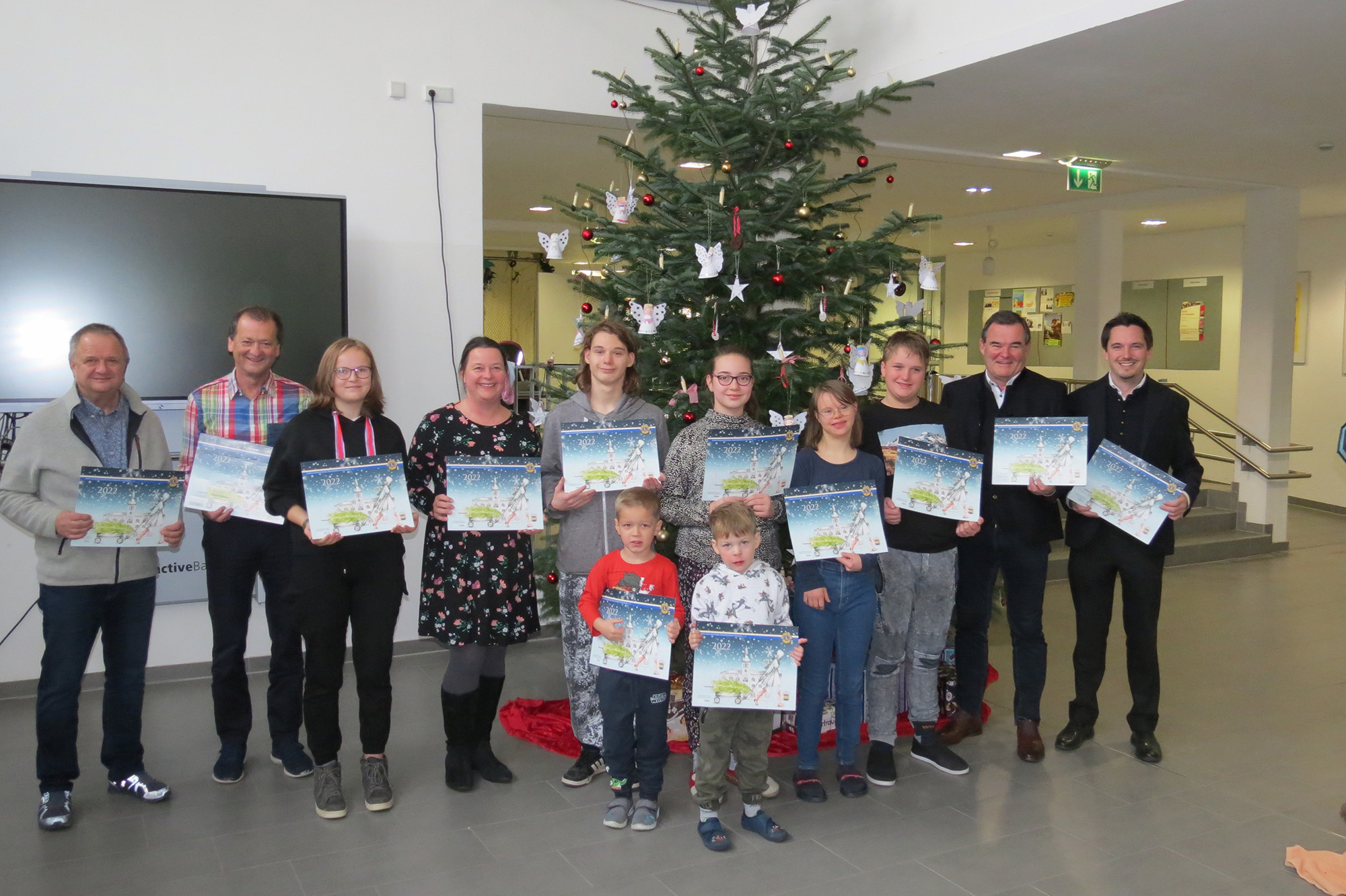 Auch in diesem Jahr gab es für alle 67 Klassen und Gruppen des Heilpädagogischen Zentrums in Pfaffenhofen und Geisenfeld einen Adventskalender des Lions Clubs Pfaffenhofen/Hallertau hintere Reihe v.l.n.r.: Anton Steinberger und Franz Schreyer (Vorsitzender und Geschäftsführer des Vereins „Hilfe für das behinderte Kind“), Laura (Schülersprecherin), Katrin Dillner (stv. Schulleiterin), Marcel (Schülersprecher), Leonie, Mariella, Raphael, Albert Gürtner (Landrat), und Johannes Hofner (Präsident Lions-Club), vorne im Bild: Jan und Symon