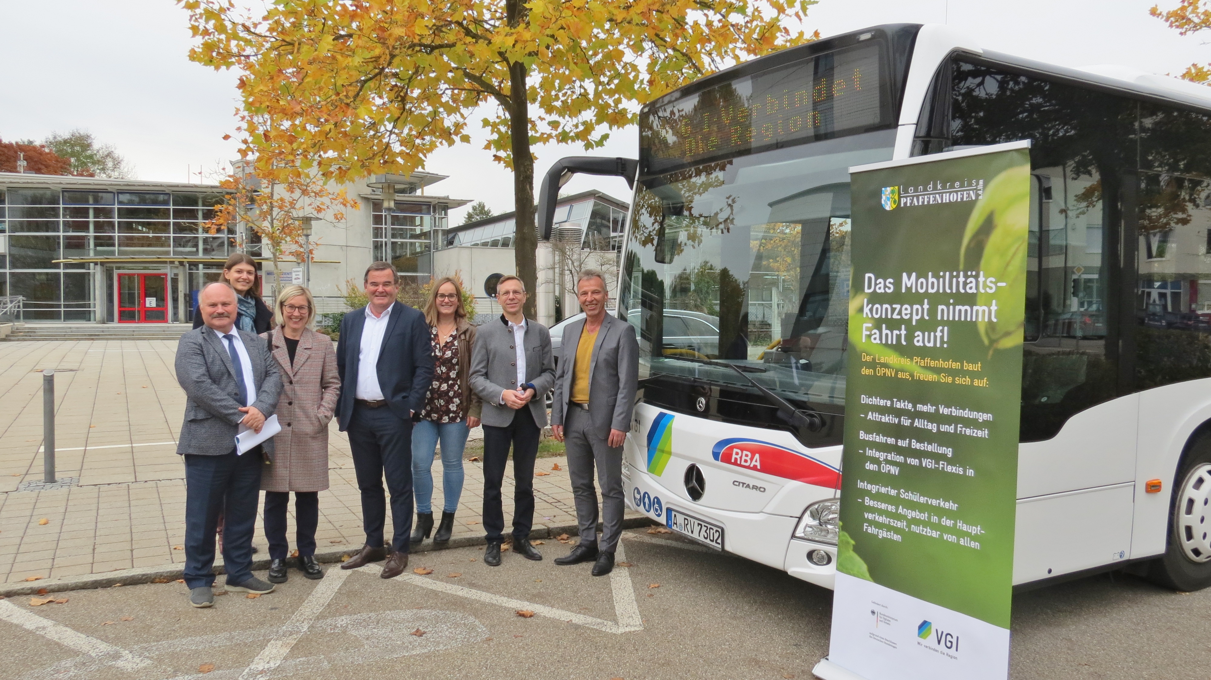 mehrere Personen stehen vor einem Bus